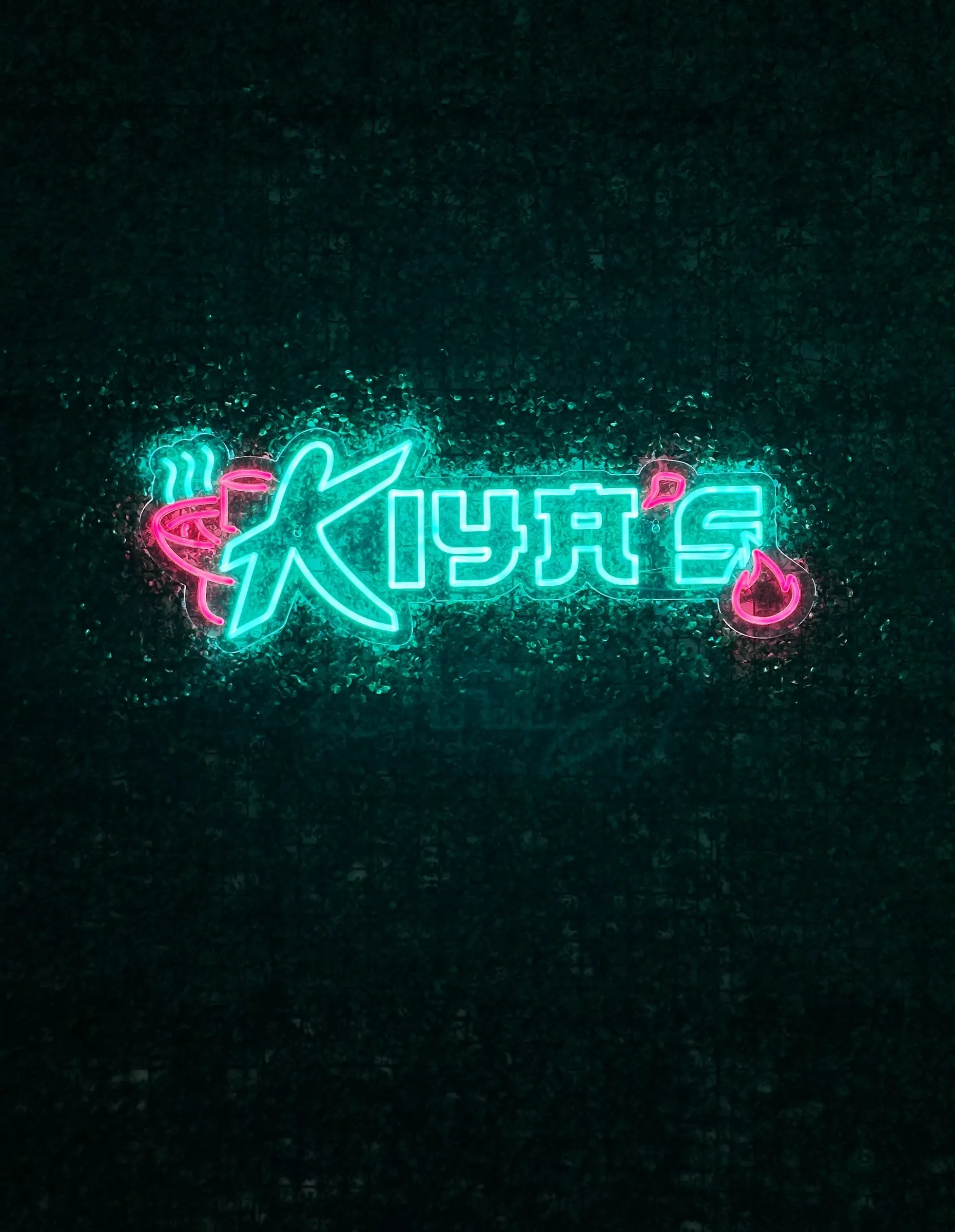 The Kiya's neon sign on the restaurant wall