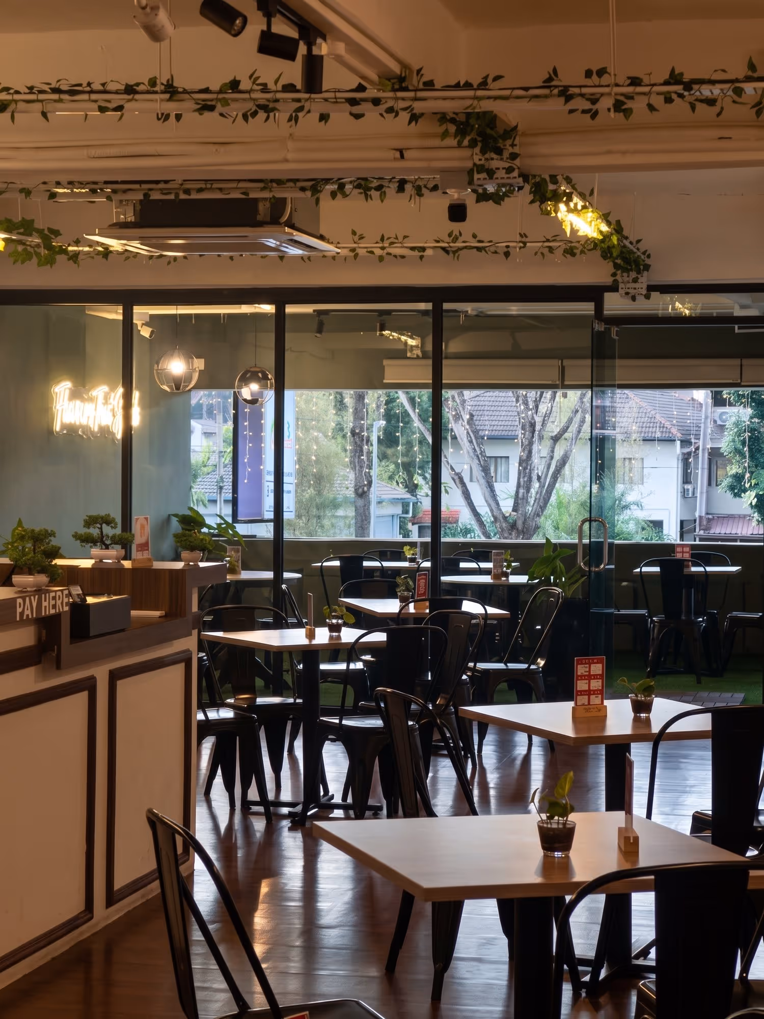 Kiya's dining room in TTDI, wooden tables under warm lamps
